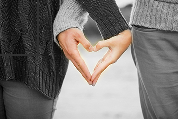 couple with heart hand sign